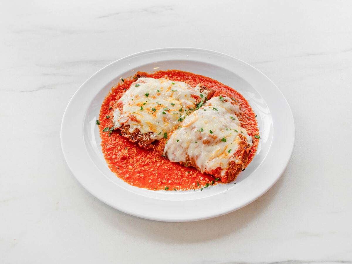 Chicken Parmesan served with tomato sauce and melted mozzarella