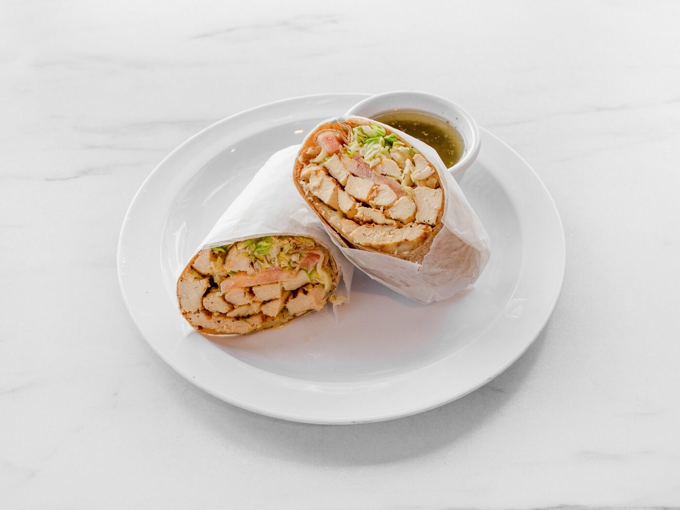 Grilled chicken wrap served with dressing